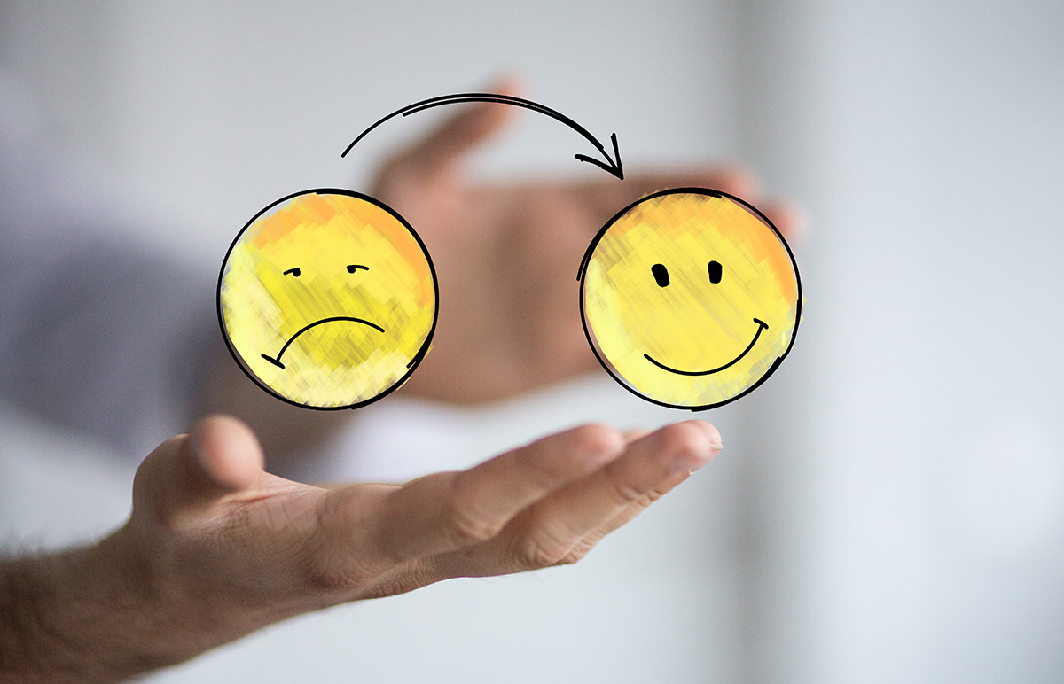 Negative Glaubenssätze auflösen, Symbolbild: Unglückliches Smiley und fröhliches Smiley
